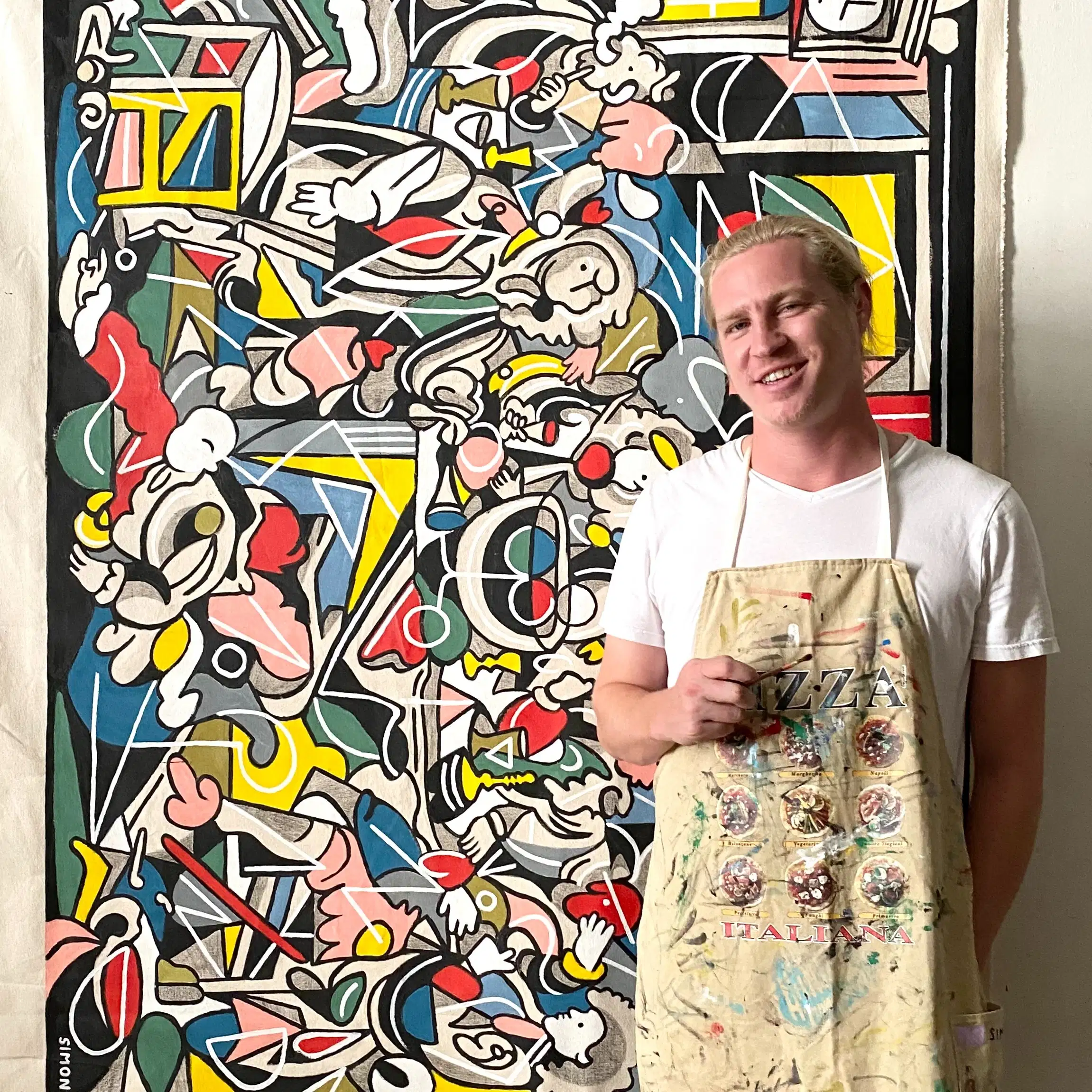 photo. of simon in front of his painting