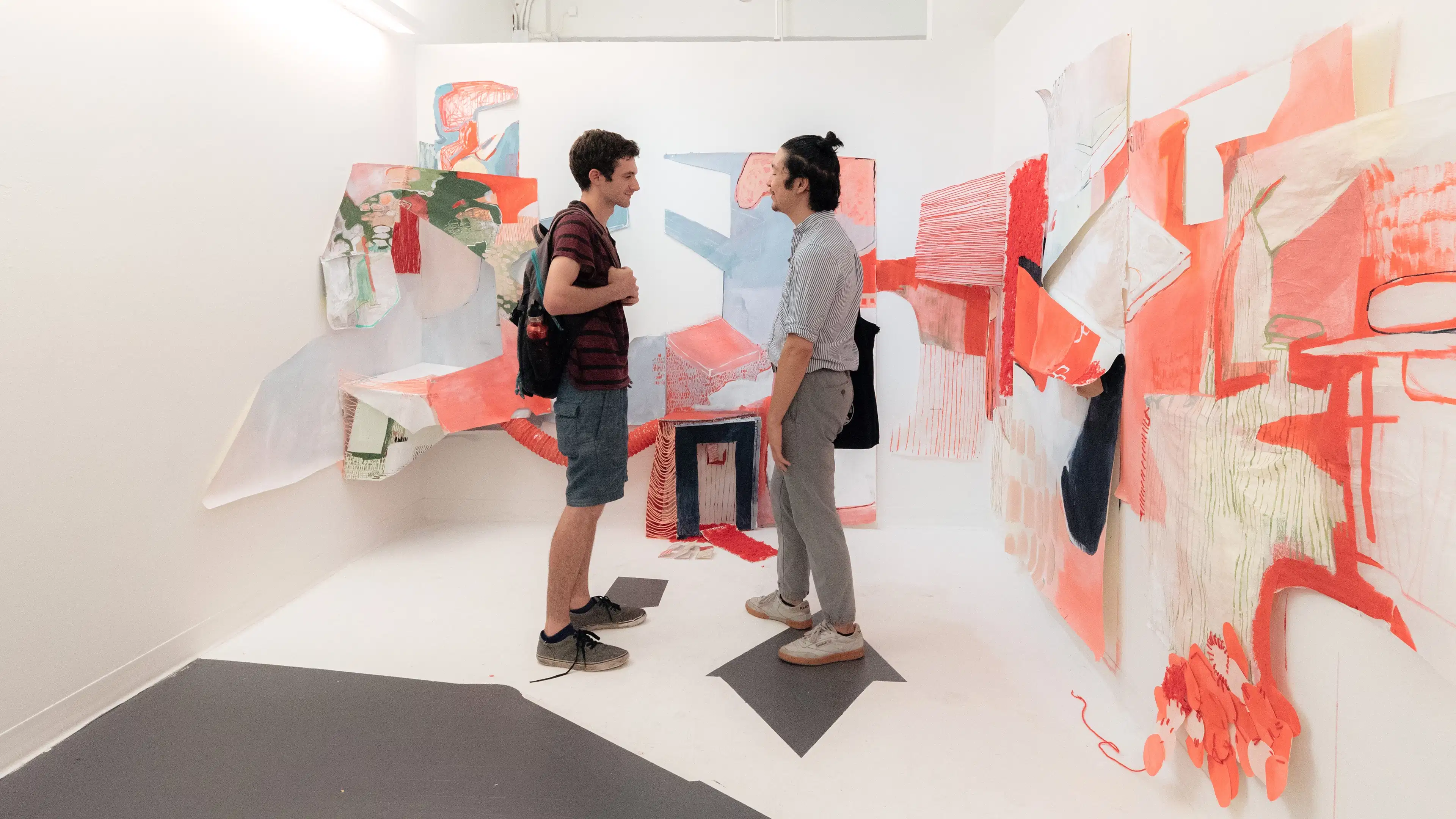 Students in the Summer Residency studio gallery in front of an instillation.
