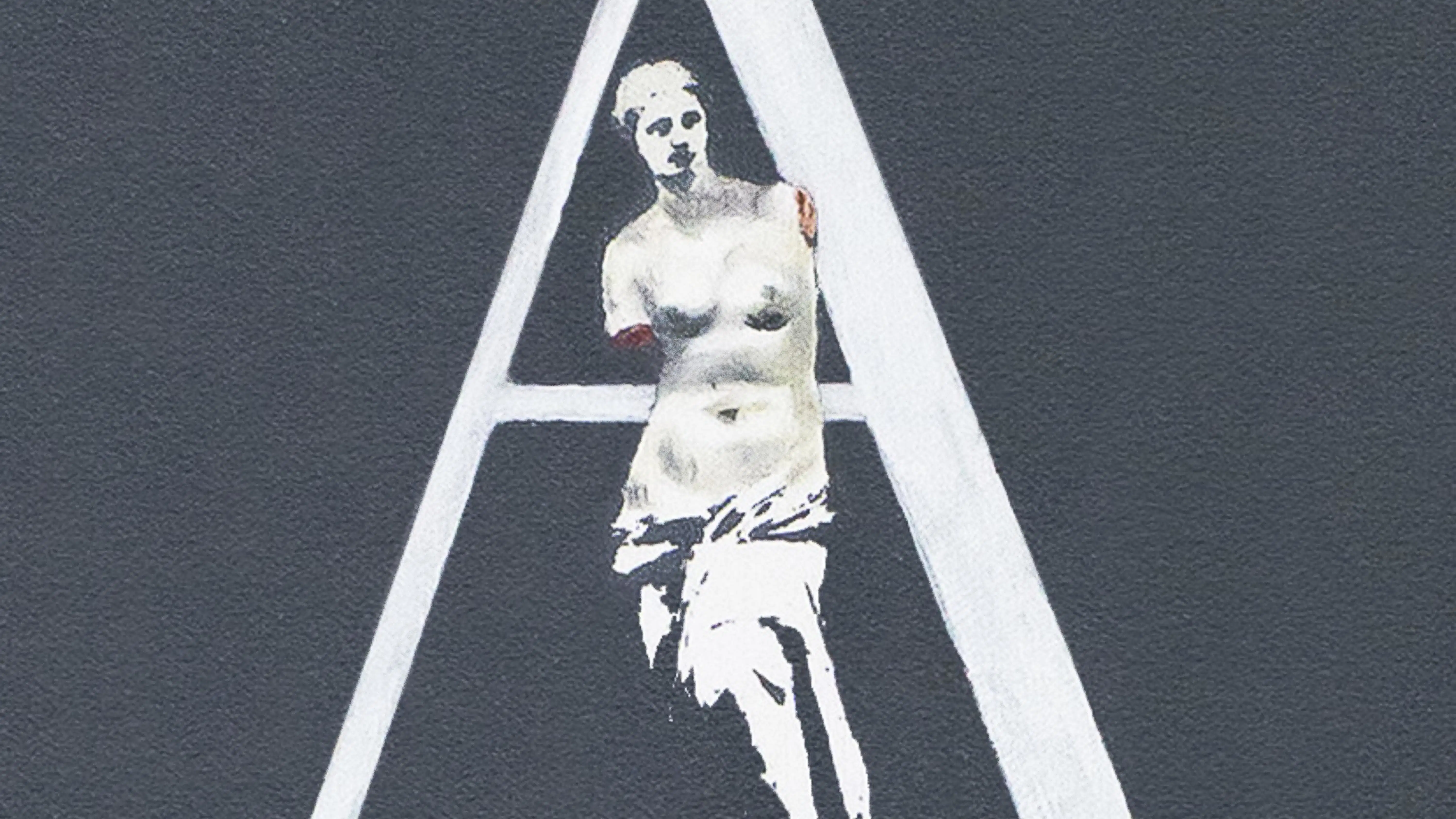 A capital A with an ancient Greek white statue of a woman with her arms missing.