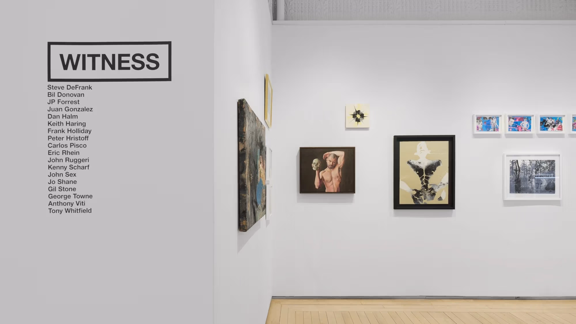 An image of a art gallery wall with various 2D works on it.