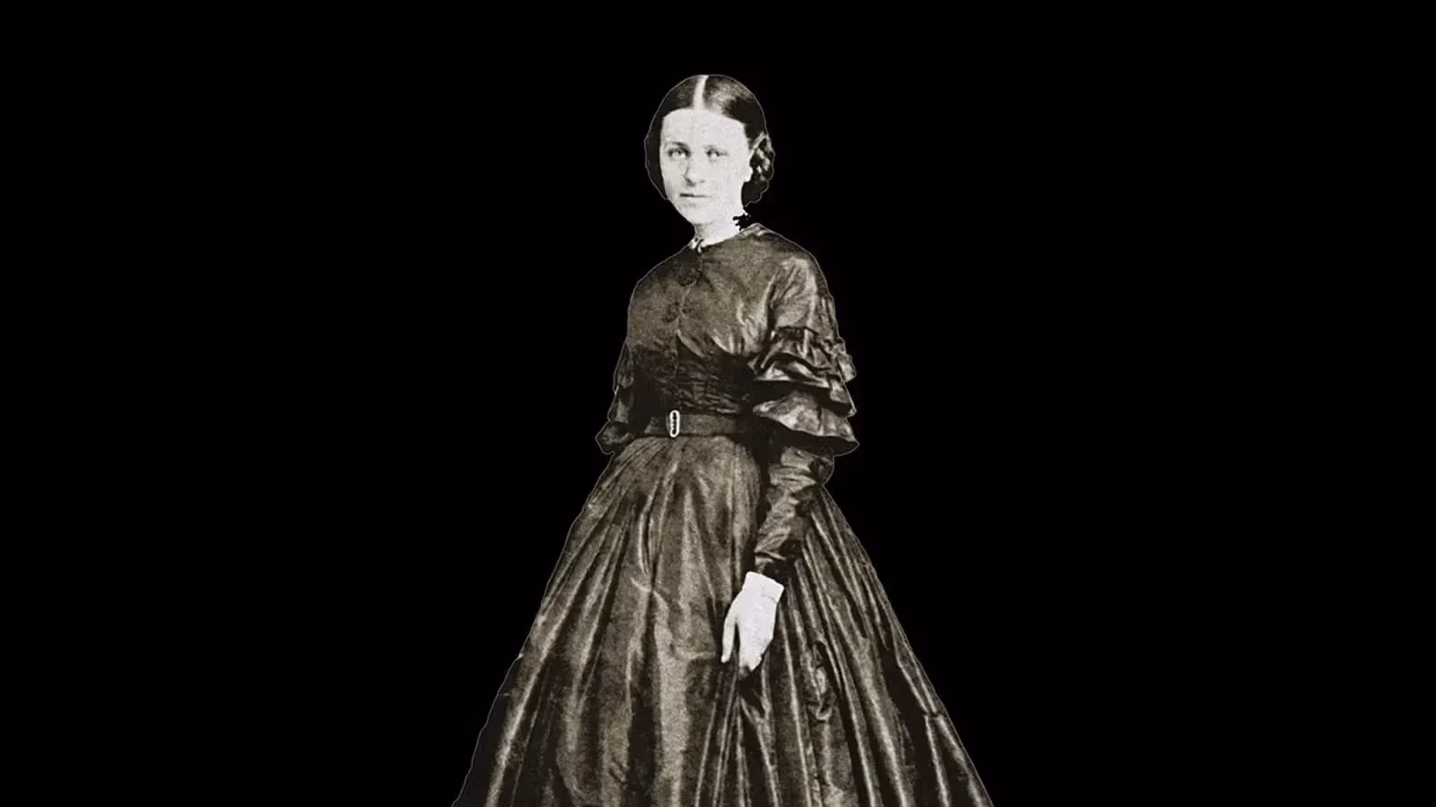 A black and white photograph of a 19th century woman against a black background.