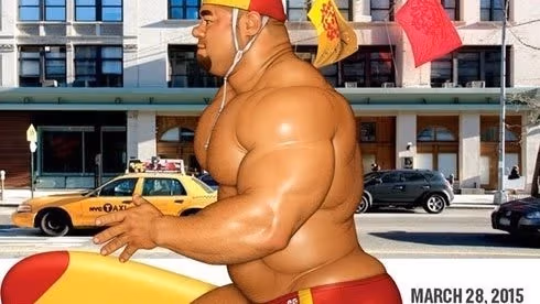 Muscular man carrying a surfboard and wearing a bathing suit and cap