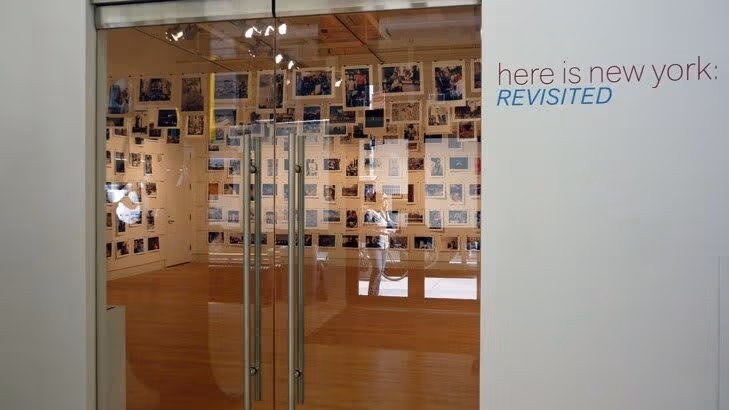 These are the glass front doors to a photo gallery featuring images of New York.