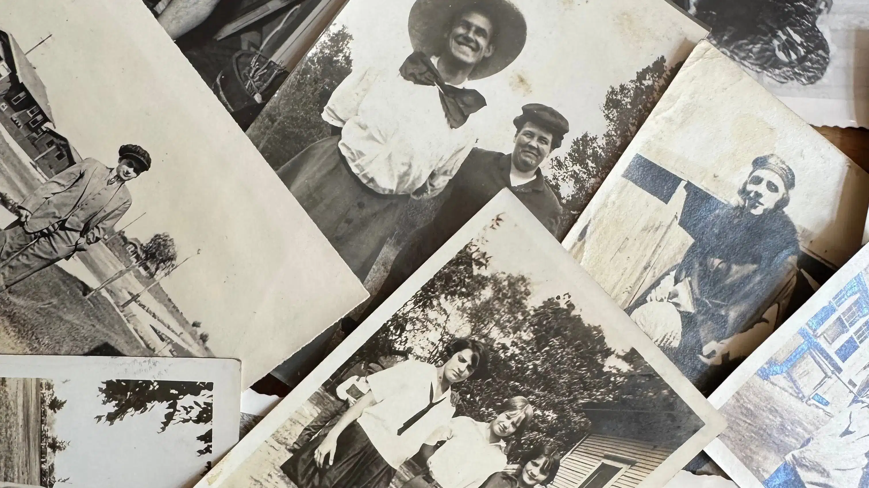 Image of black and white photographs in a pile.