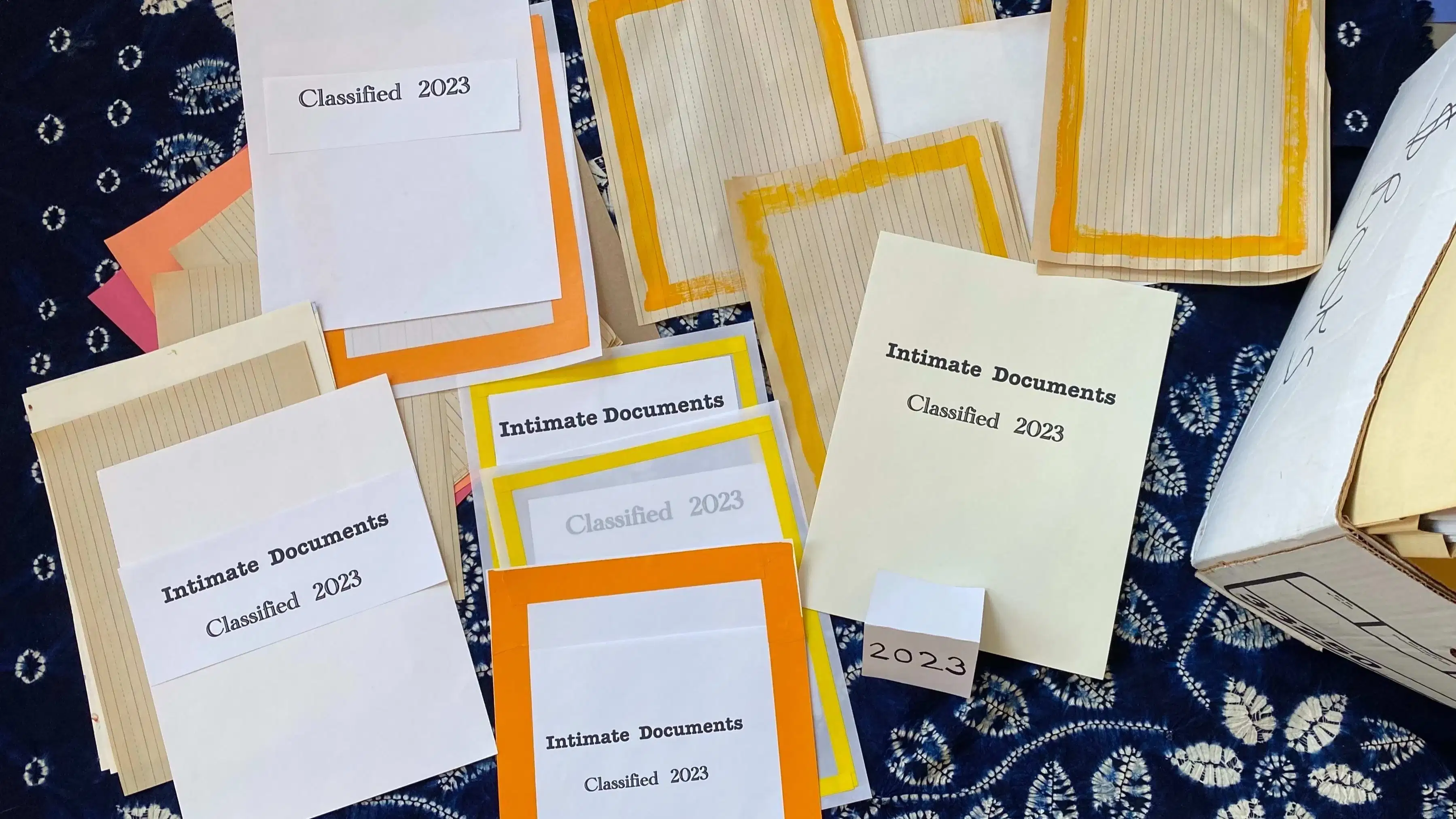 Image of seeminlgy confidential documents spread blue tablecloth with white flower designs.  The image is based off the recently retrieved classified documents at Mar-a-Lago.