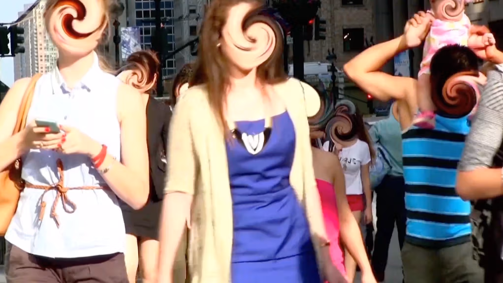 An image by Manuel DeLanda of passerbys on a busy street, with each of their faces swirled and distorted.
