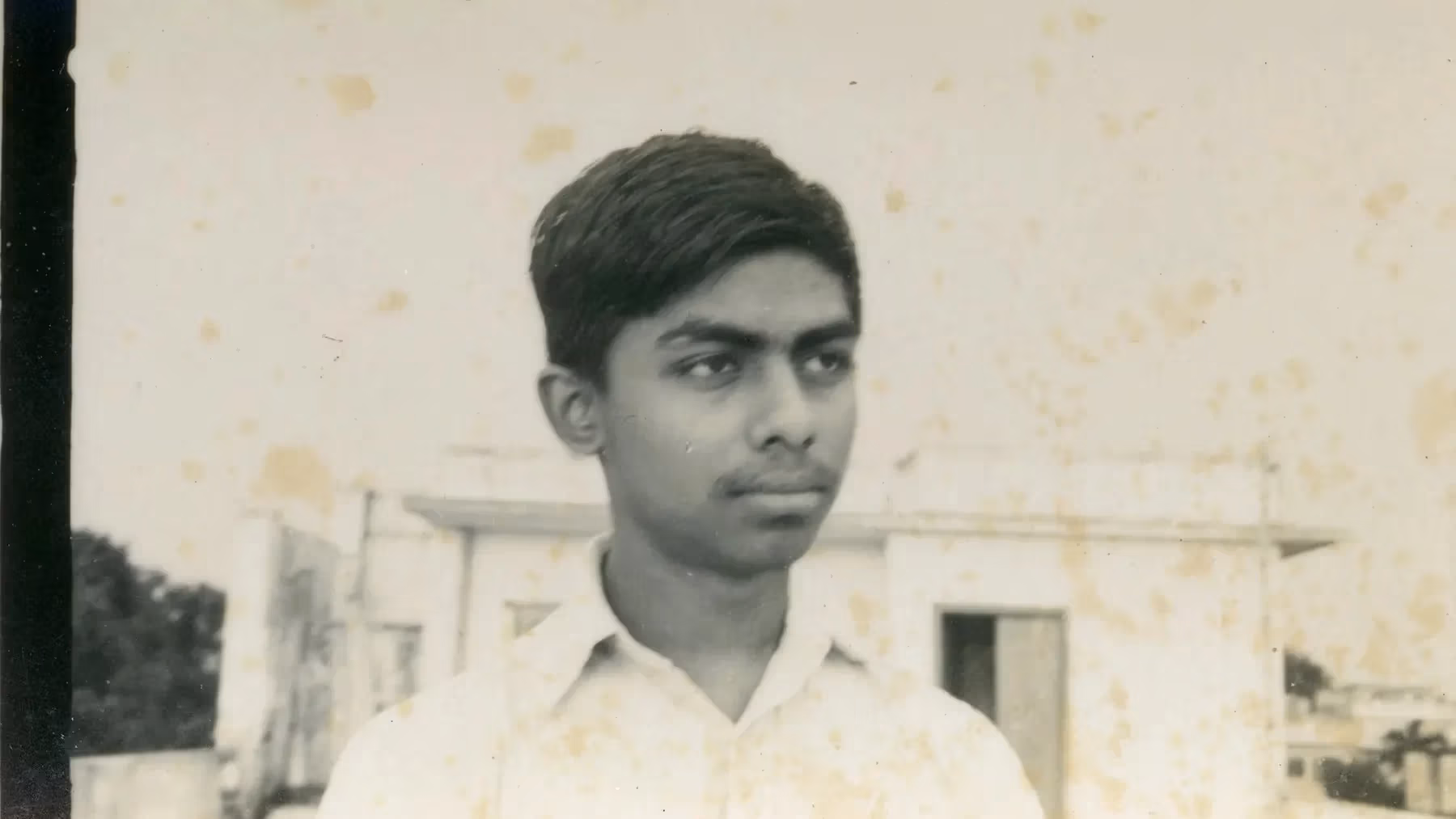 a black and white photo of a man in a white shirt