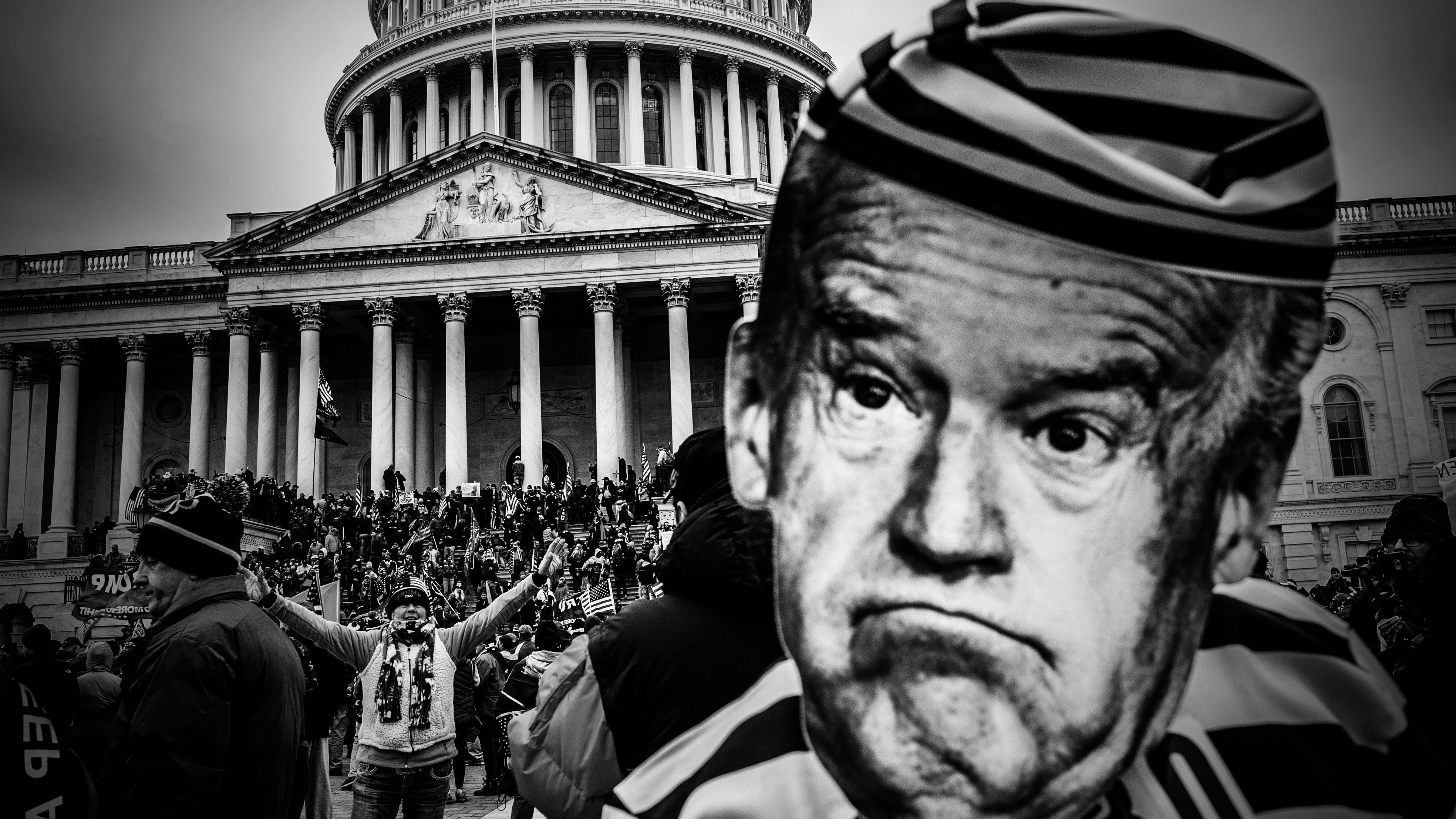 Riot in front of Capitol Hill with Joe Biden's face enlarged to the right. 