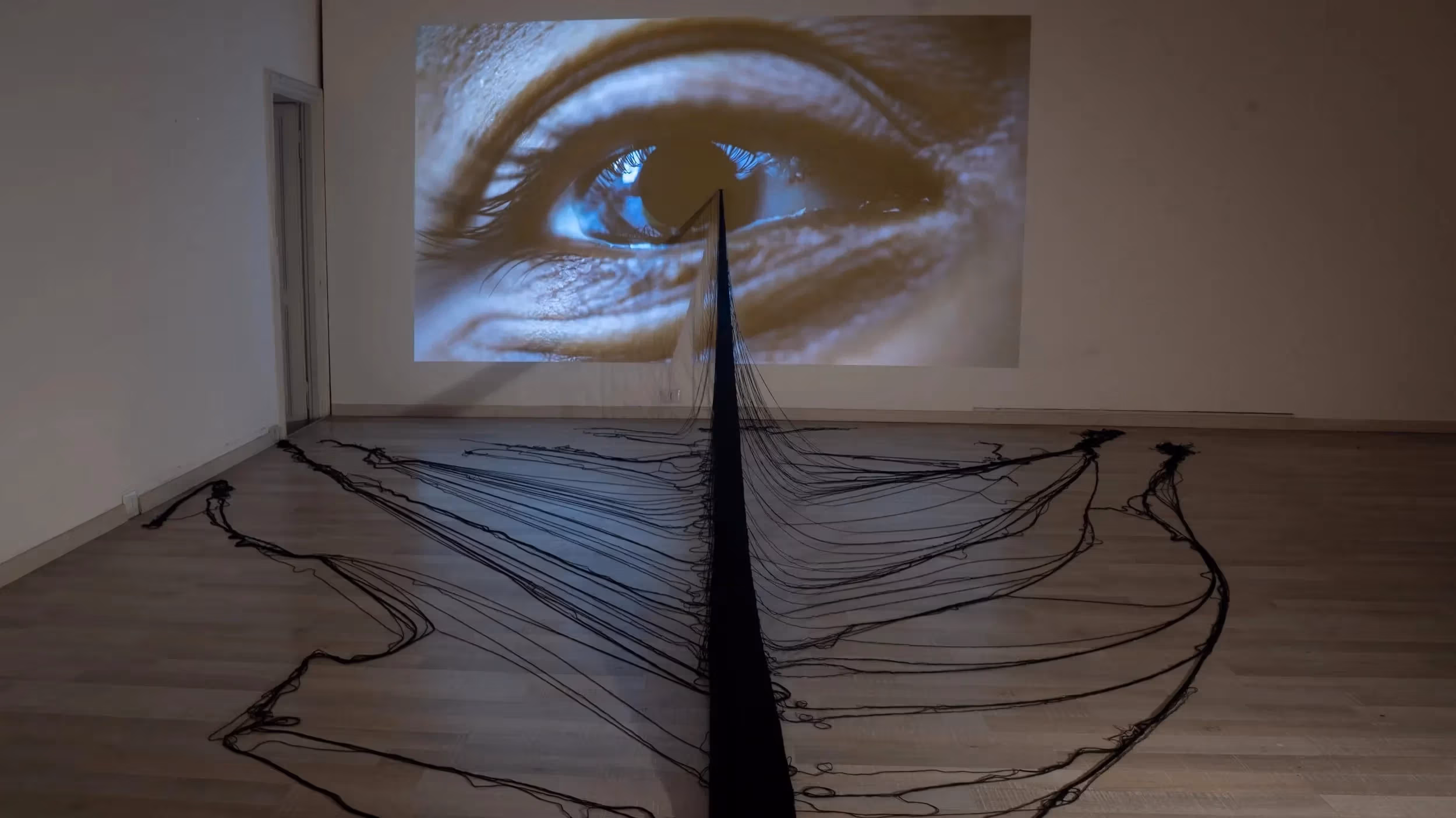 Jeanine Oleson, “In plane site”, 2024, installation includes hand-made cotton weaving and video projection 