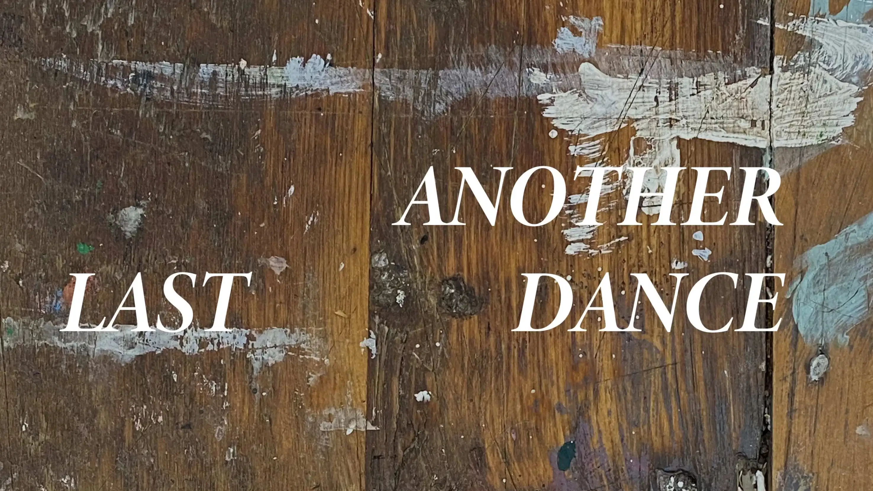 Poster with text including details for open studios event.  Text is white and the background is an old, wooden floor with splattered paint.