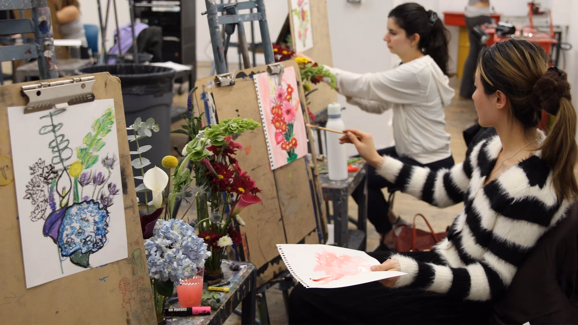 two students painting flowers