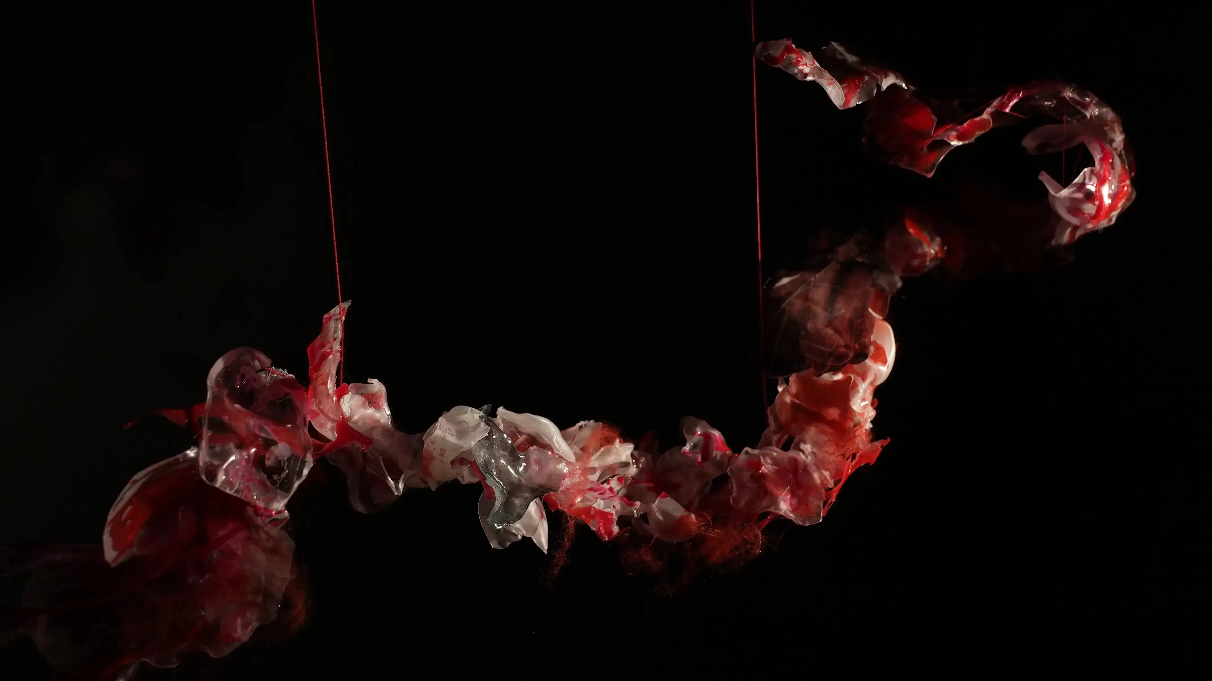 Art installation evoking the flow and connection of rivers and women's enduring kinship, through mixed media and symbolic threads.