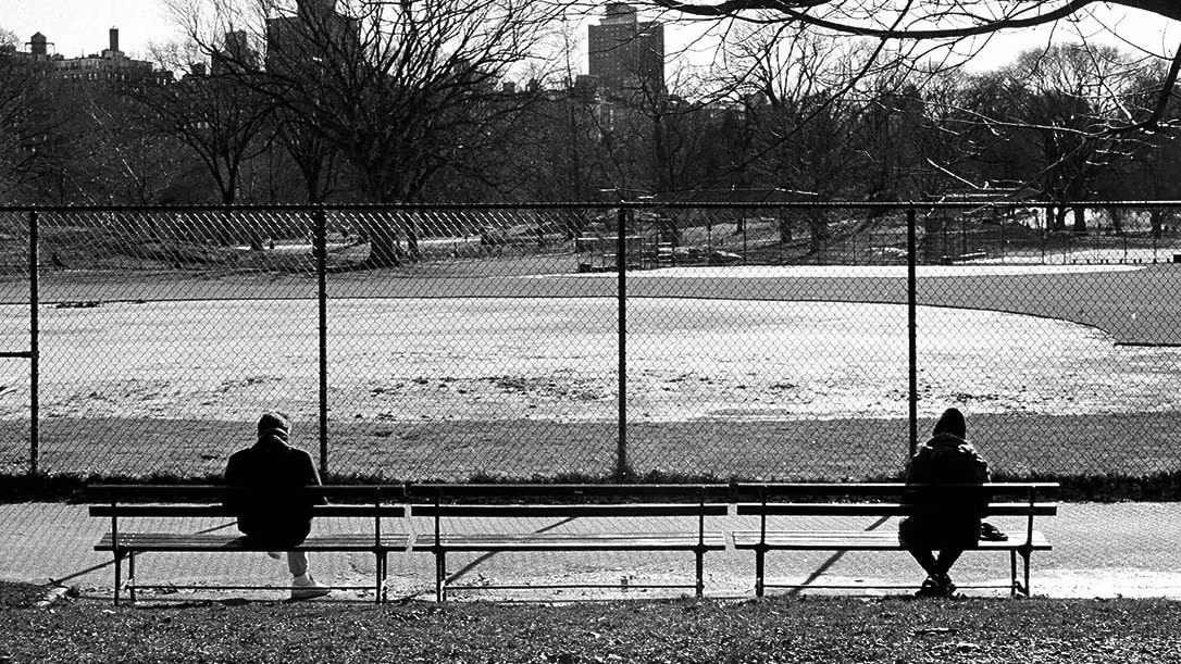 A diptych of two people sitting on a bench in front of a park at opposite ends and then sitting next to one another.