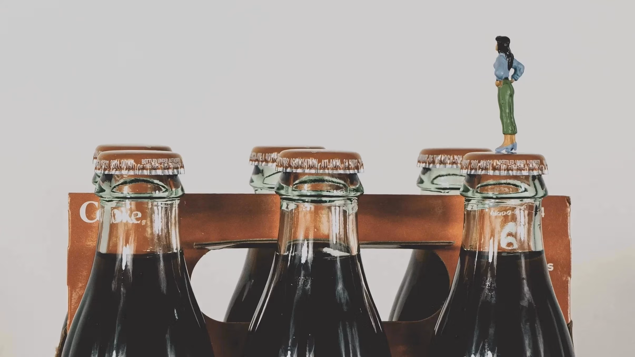 Still life, miniature standing on Coca-Cola product