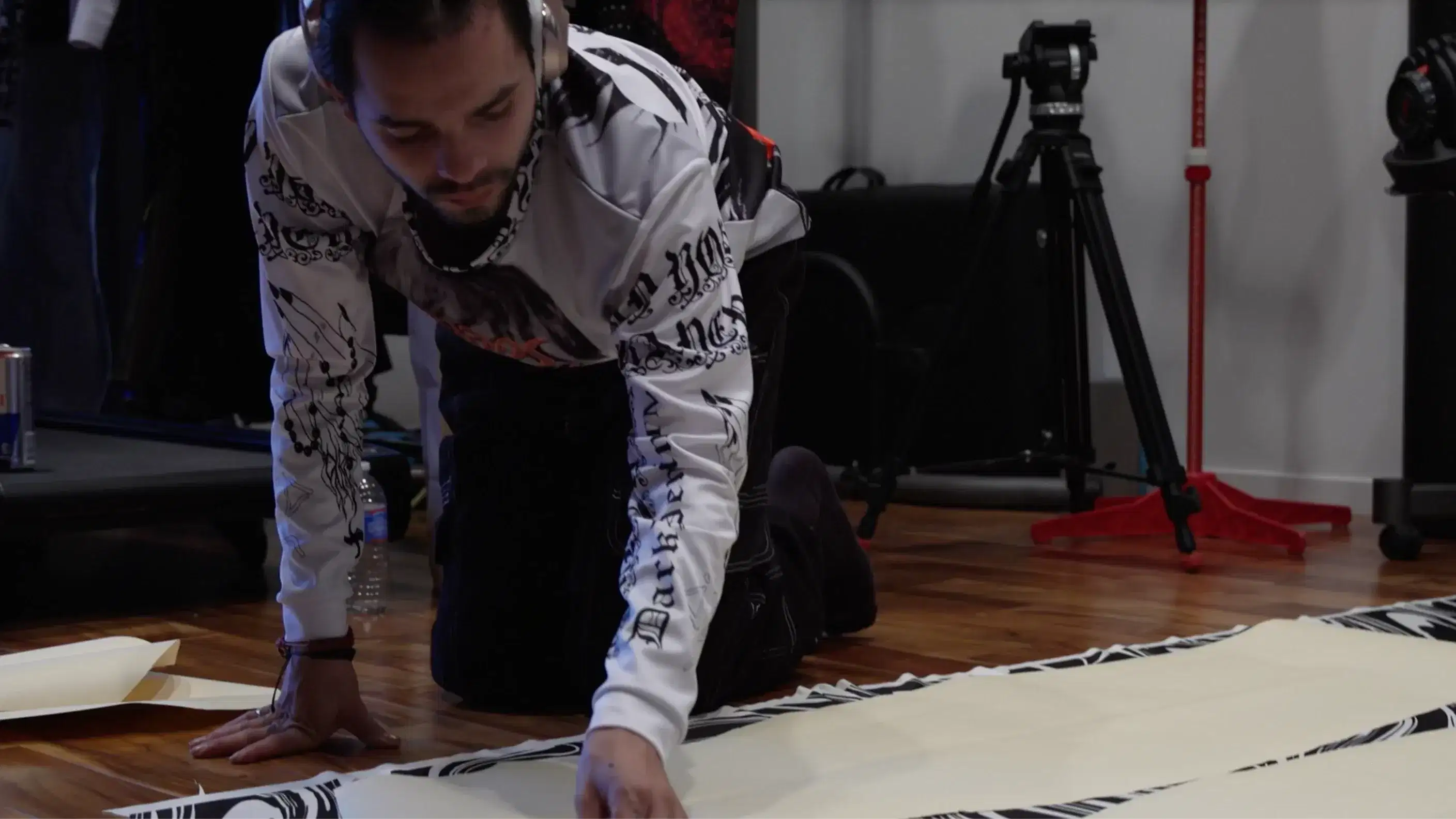 person leaning on ground, making a garment 