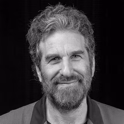 a person with a beard looking at the camera and smiling