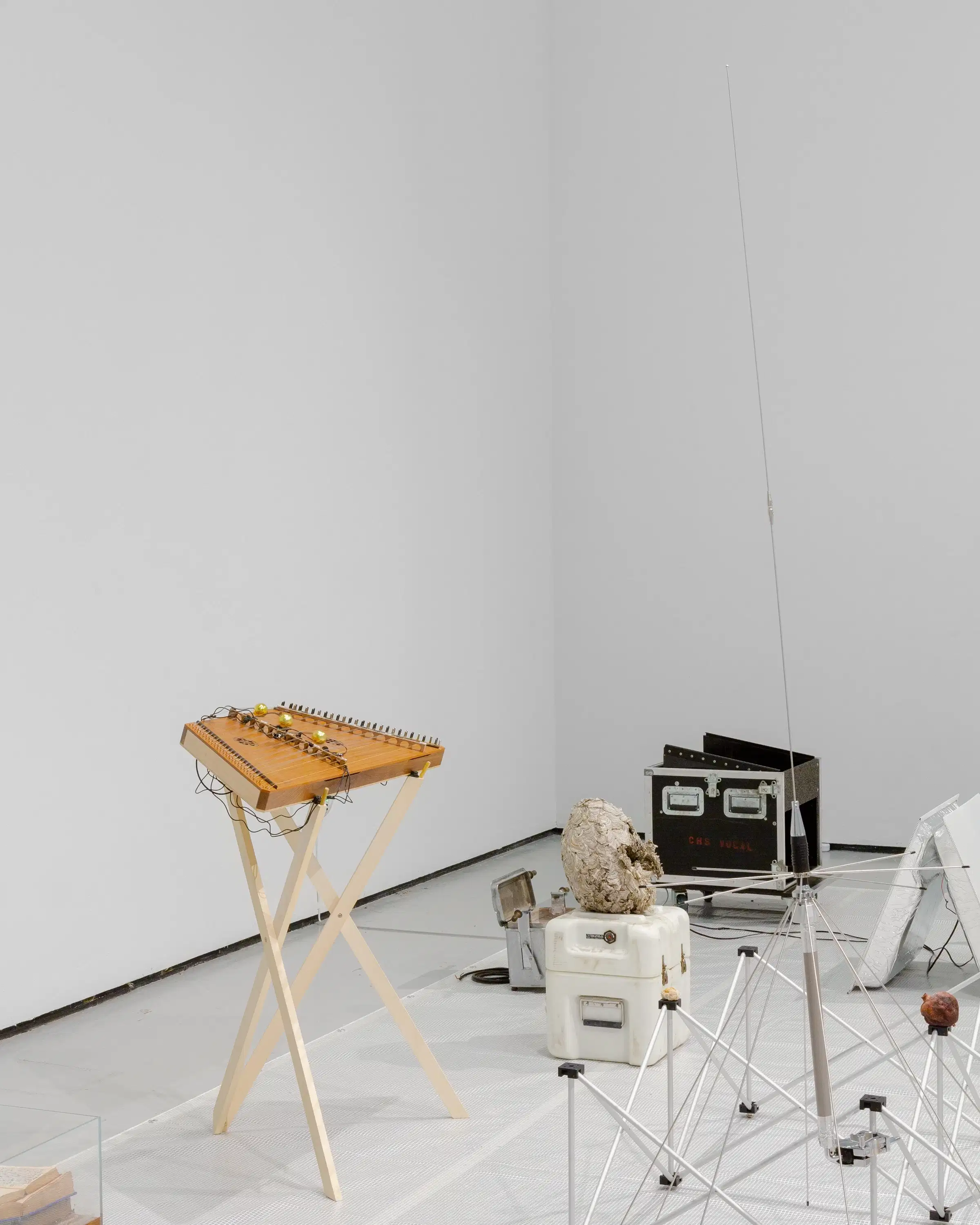Installation by Stephen Lordan. The image shows various objects laid out on the floor in light grey room.