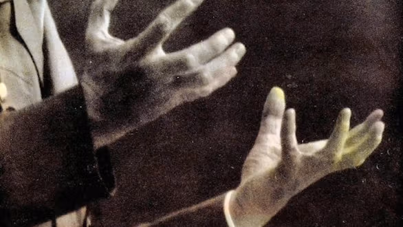a man's hands grasping for something