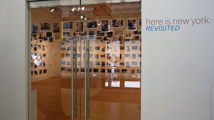 These are the glass front doors to a photo gallery featuring images of New York.