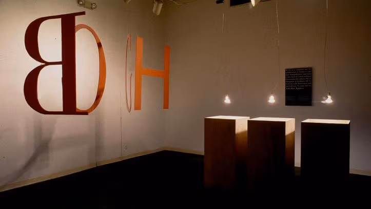 An art showcase containing letters and lights and boxes.