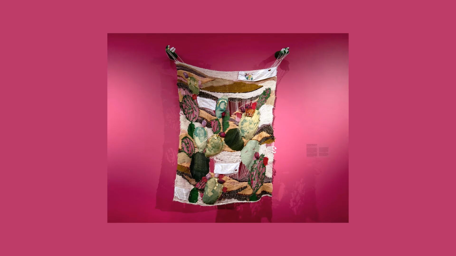 Jessica Elena Aquino, Cactus of Jessie, 2025, Frame loom weaving, indigo and cochineal-dyed yarn; synthetic yarn, clothespins, beads, screenprint on silk habotai and silk organza, sewing thread, embroidery on letterpress satin ribbon, 36 x 60 x 11.5 inches. 