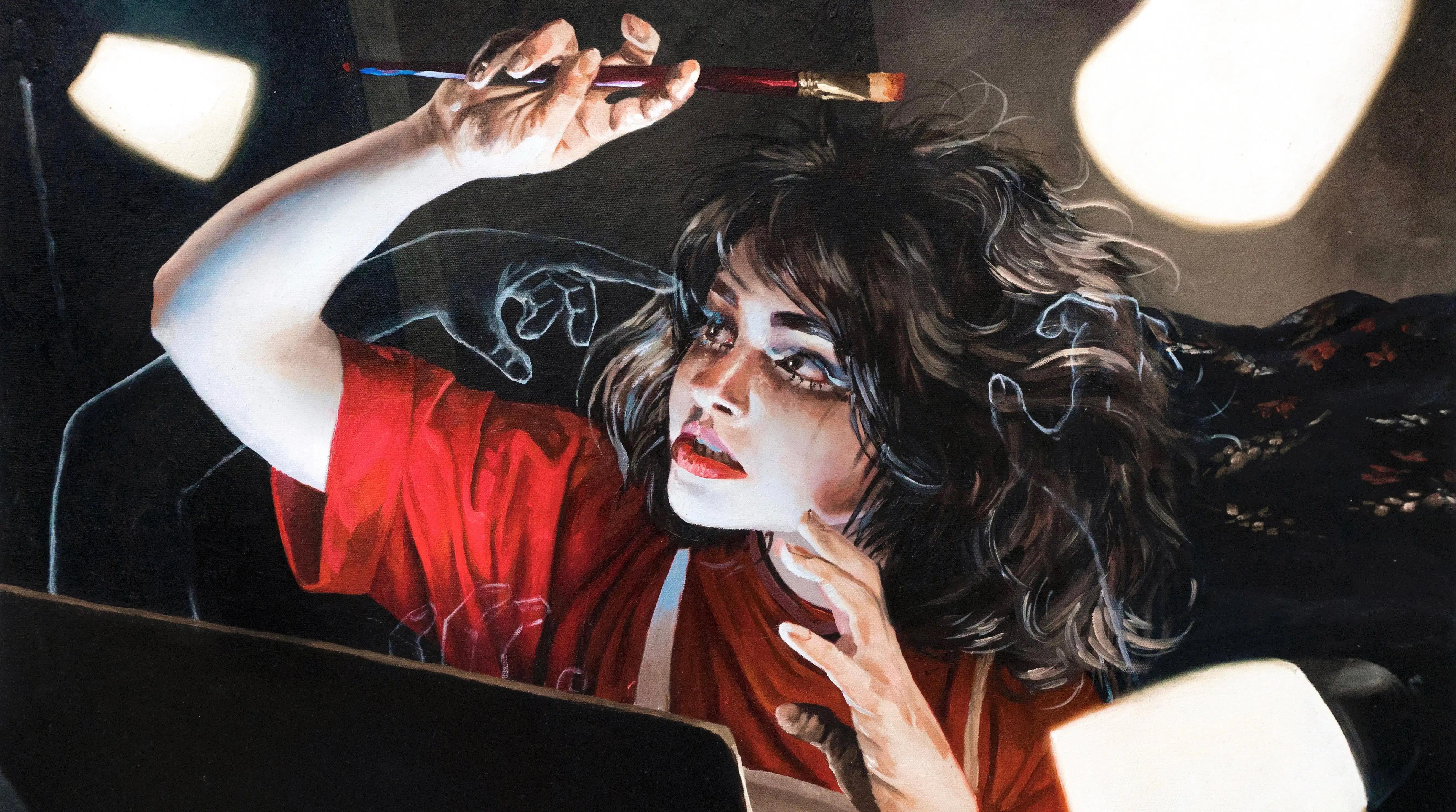 Self-portrait of a young female artist painting while illuminated by various light sources.