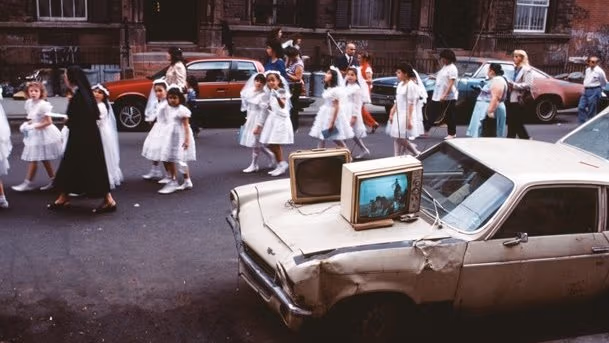 Little girls are wear a white color dress and walking in a street