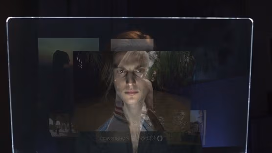 A man peers into a video screen.