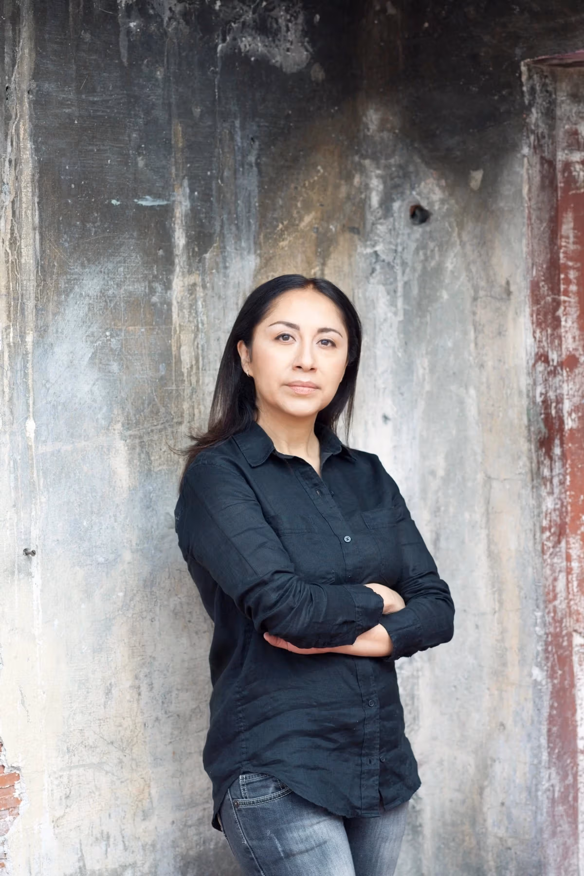 Picture of Minerva Cuevas standing against cement wall