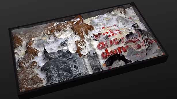 Multi dimensional art piece, appearing to mountains covered in snow and dirt.