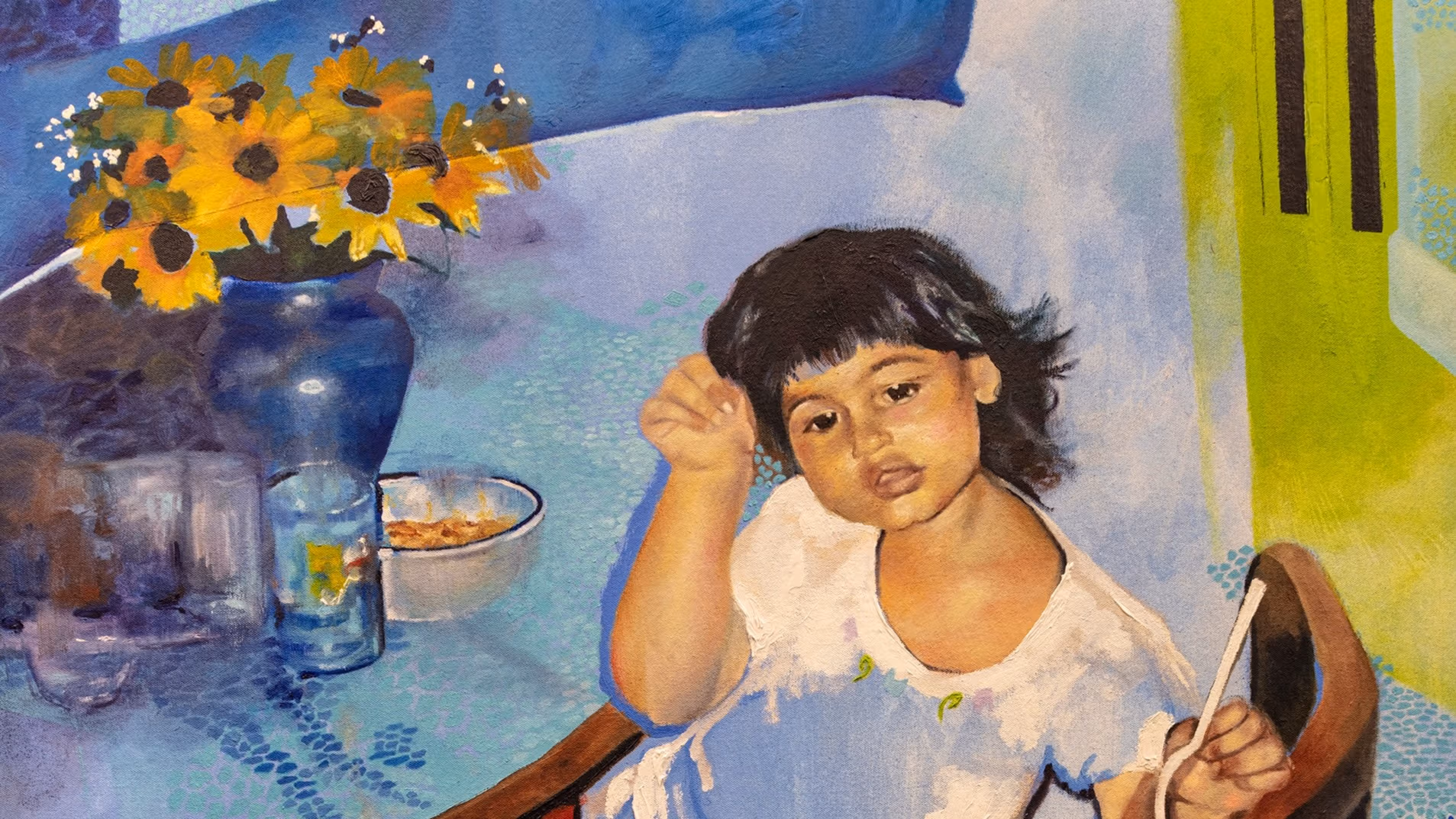 Painting of a young girl sitting in a chair surrounded by various color fields of blue. On the table to her left is a vase containing sunflowers.