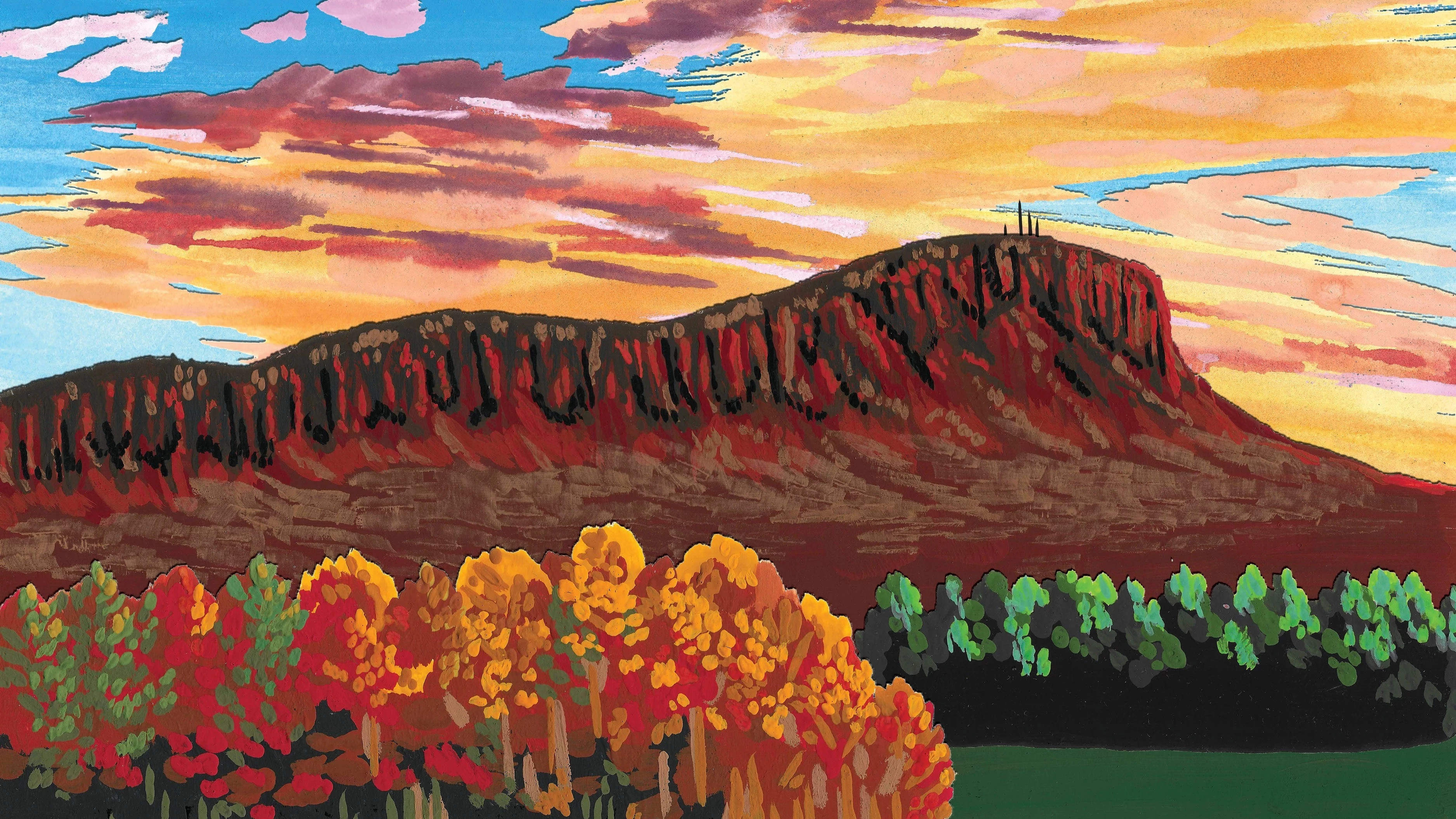 A plateau mountain rises above colorful autumn trees under a sky filled with vibrant sunset clouds.