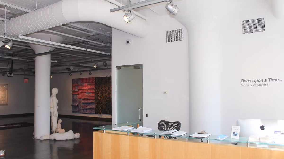 View of art gallery space showing information desk.