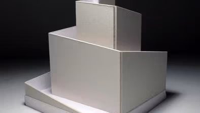 Eight black and white photo of a sculpture that is rectangle and square and multi leveled.