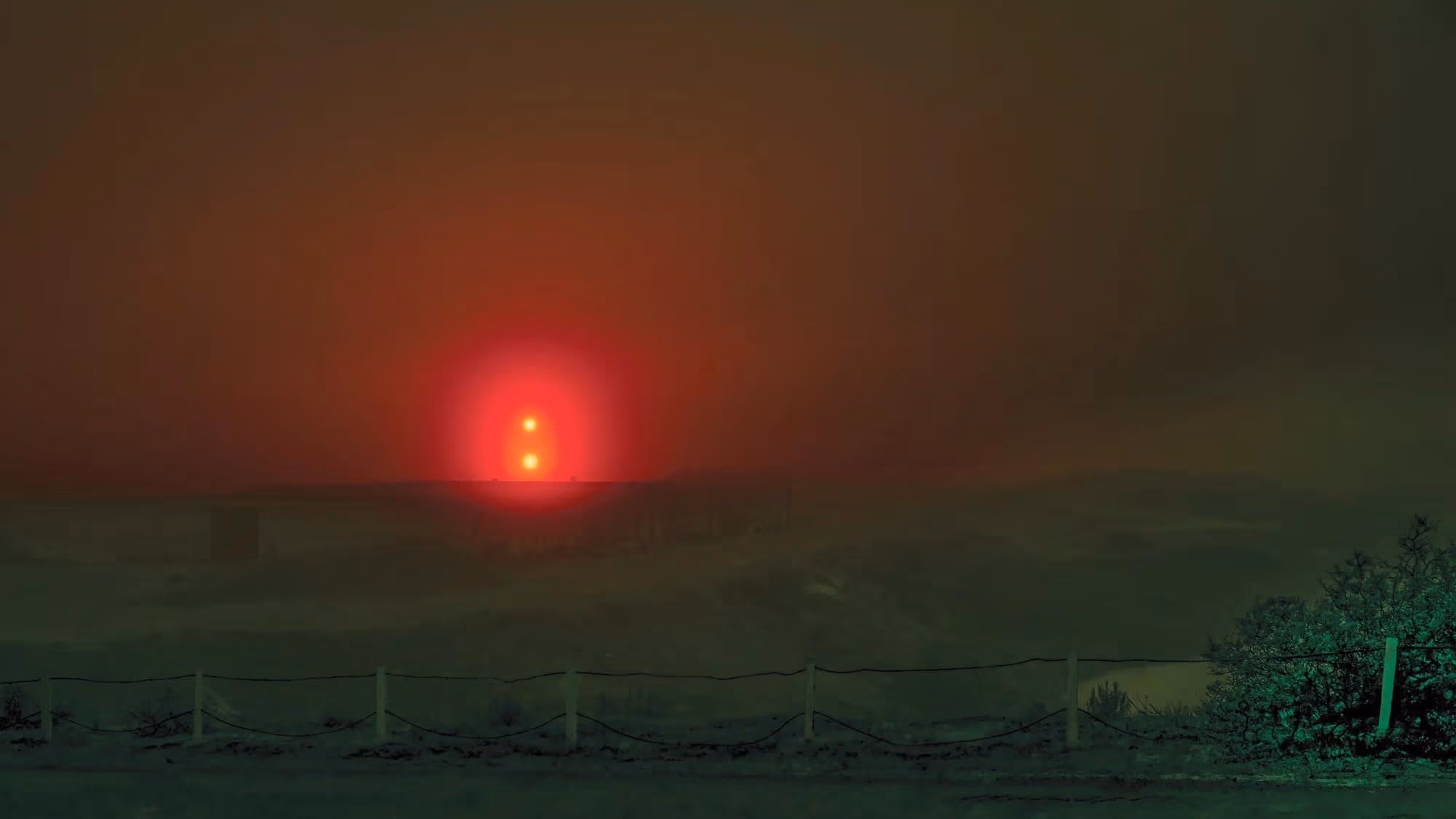 Horizontal photograph of red light at night.