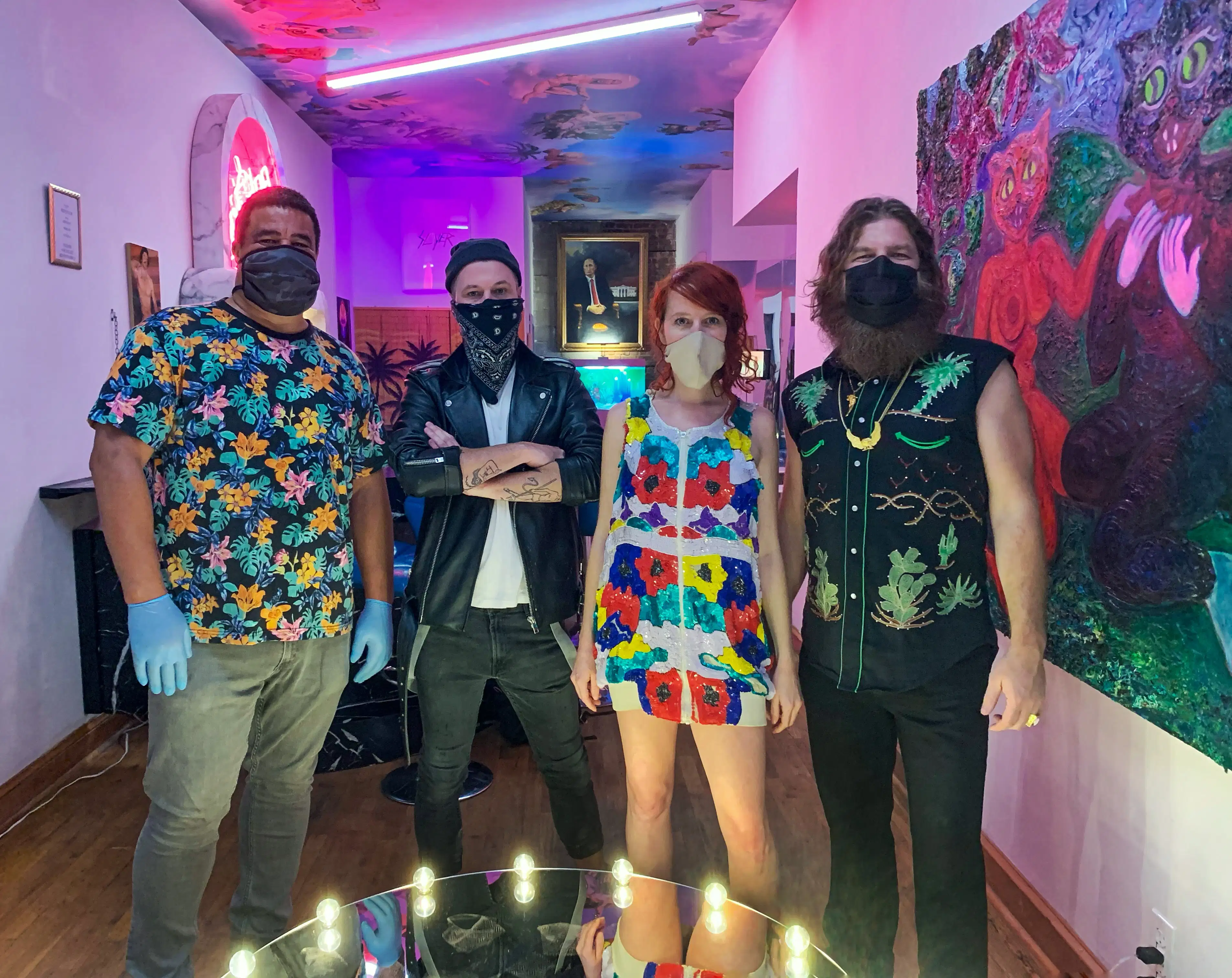 A photograph of four people inside a nightclub-like venue.