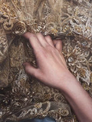 A hand feeling some fabric.