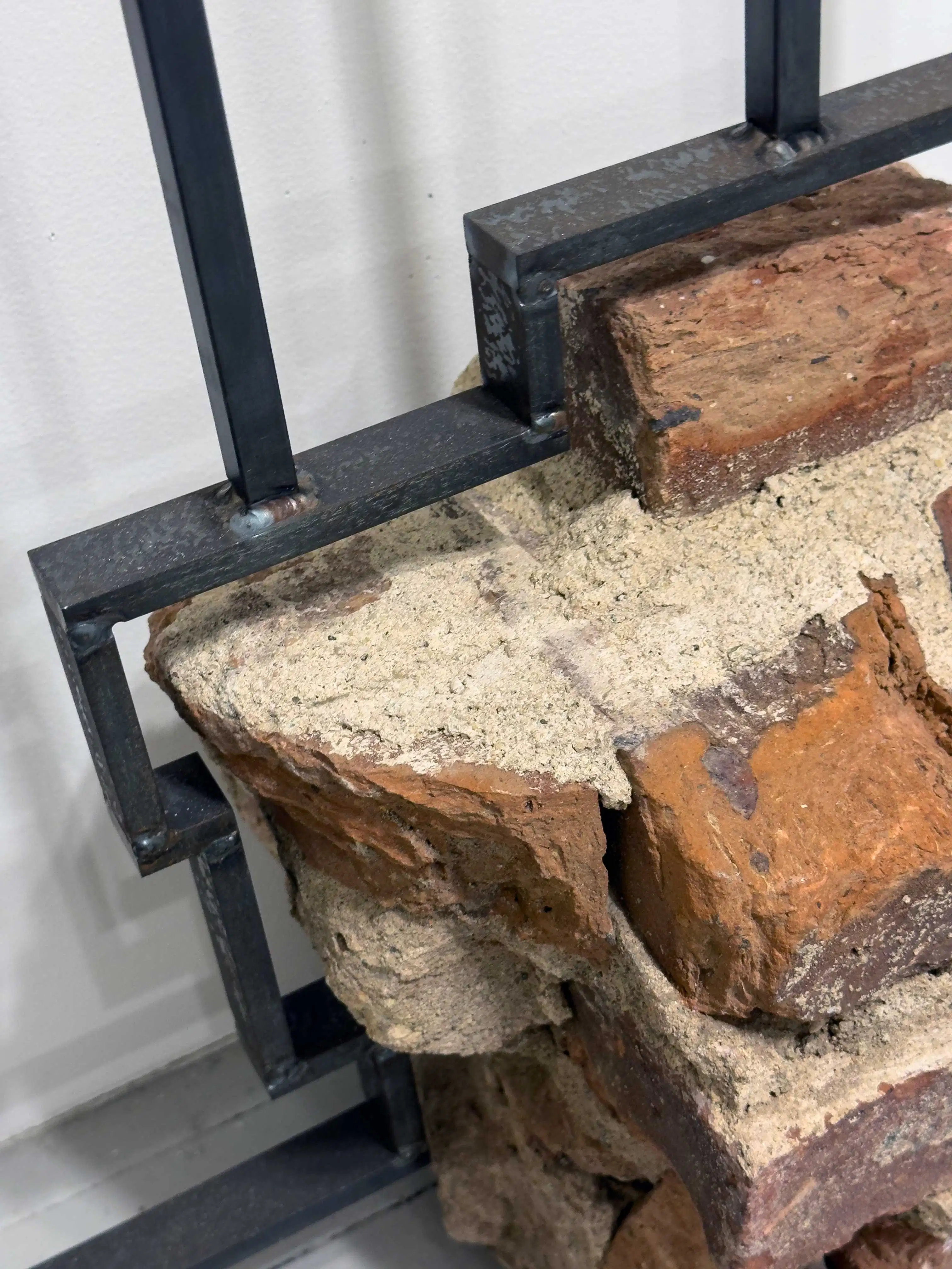 Detail image of a sculpture made of bricks over an iron armature.