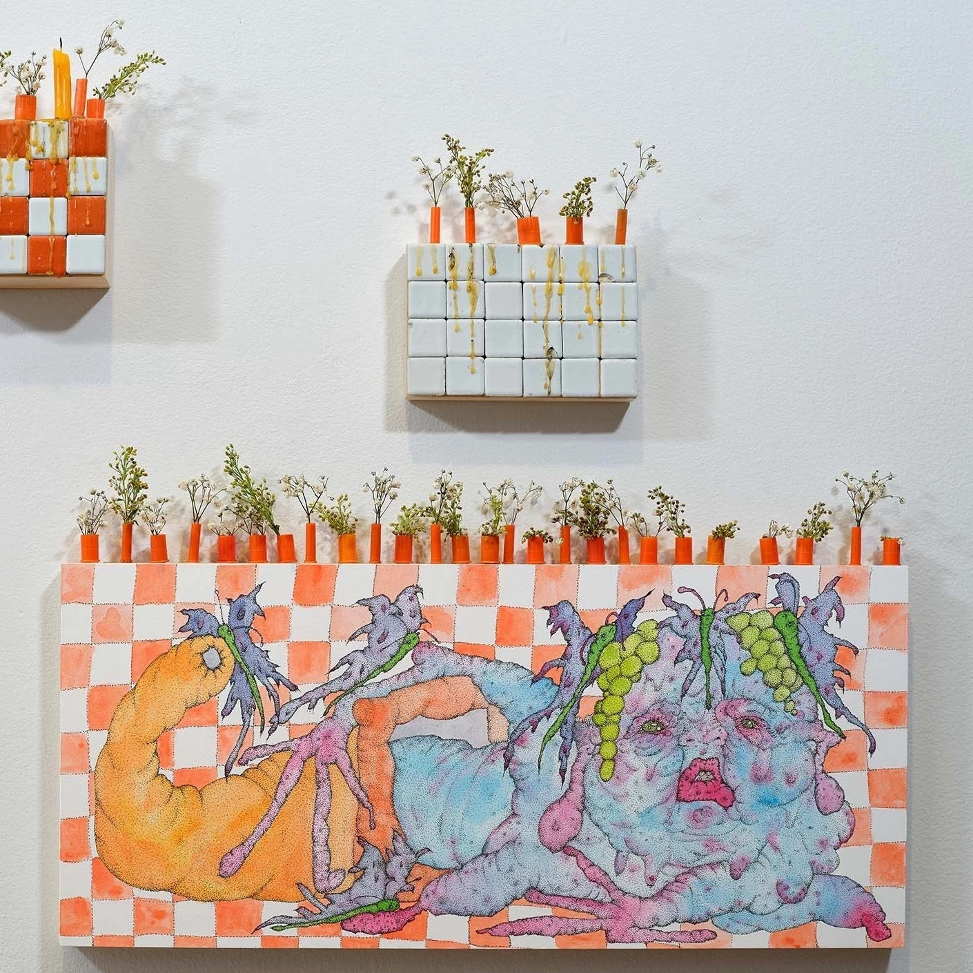 Orange and white checkered block with bulbous figure and greens on top