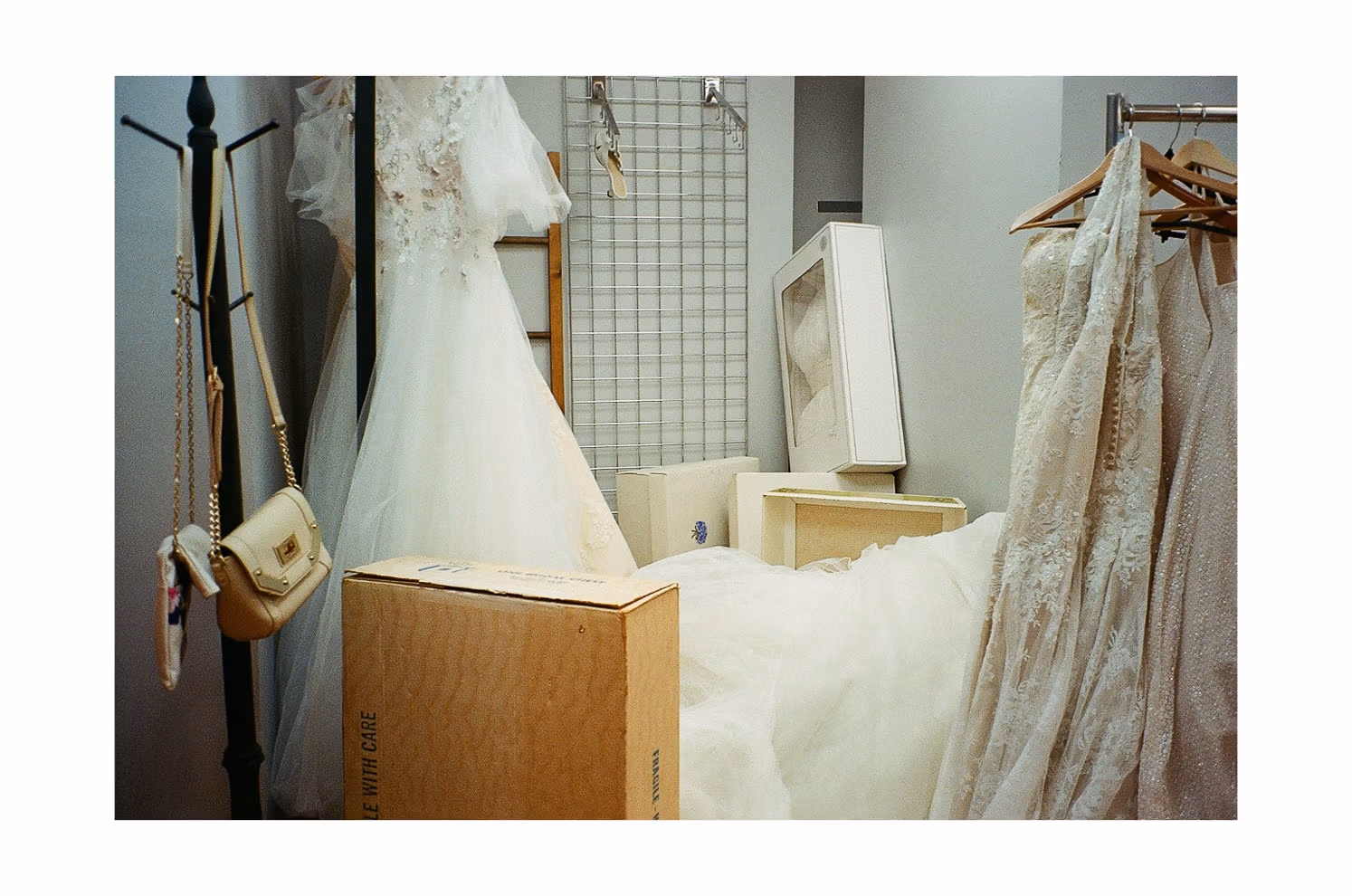 Still from a video by SVA BFA Photography and Video student Geena Janovsky, featuring a dressing room with many wedding gowns hanging and one on the ground.