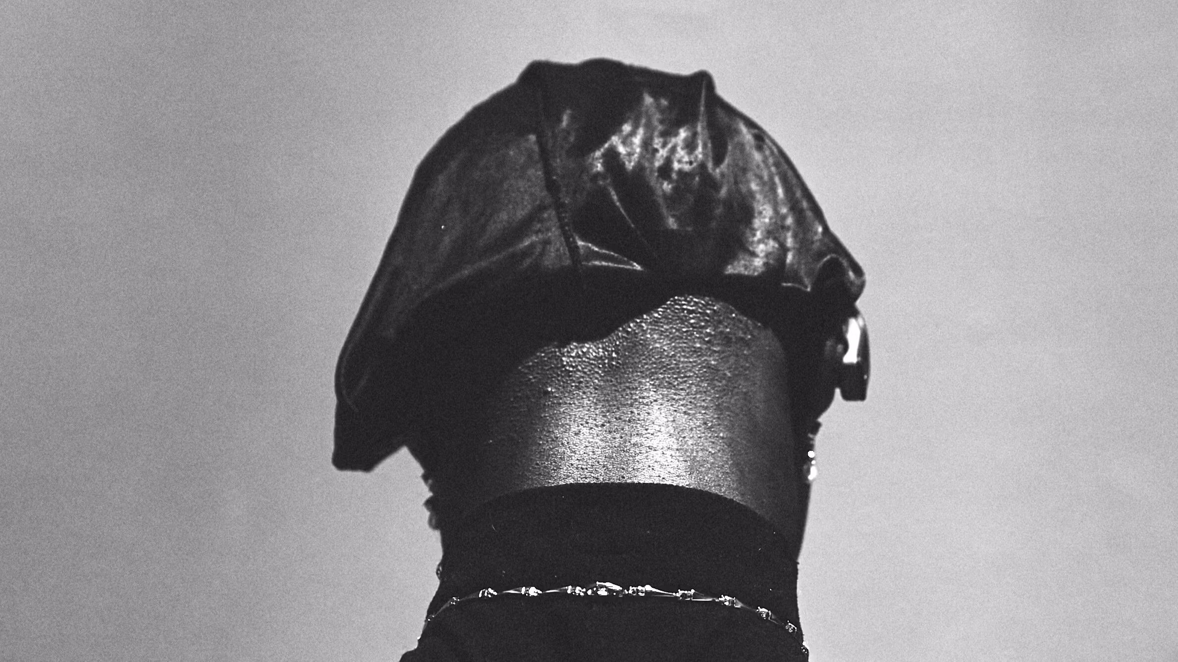 Black and white image of the back of someone's head. 