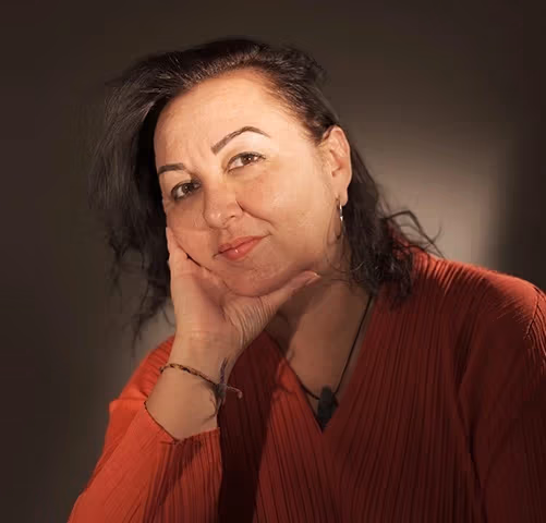 a person poses with their head in their hands