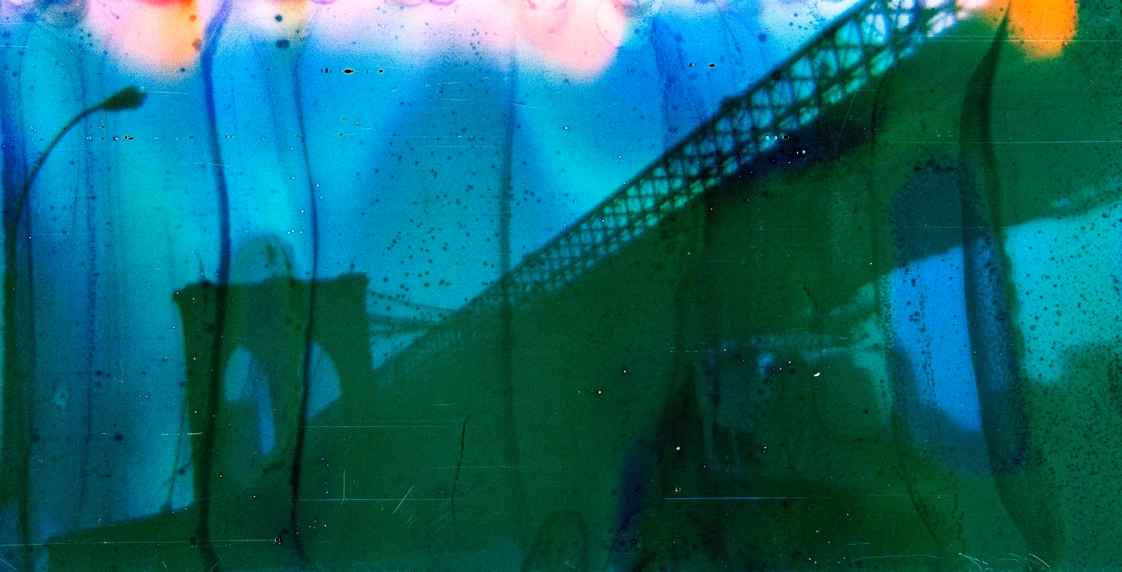 Abstract image of a bridge with an arch and cables, layered in vivid green, blue, and orange tones. The mood is surreal and dreamlike.