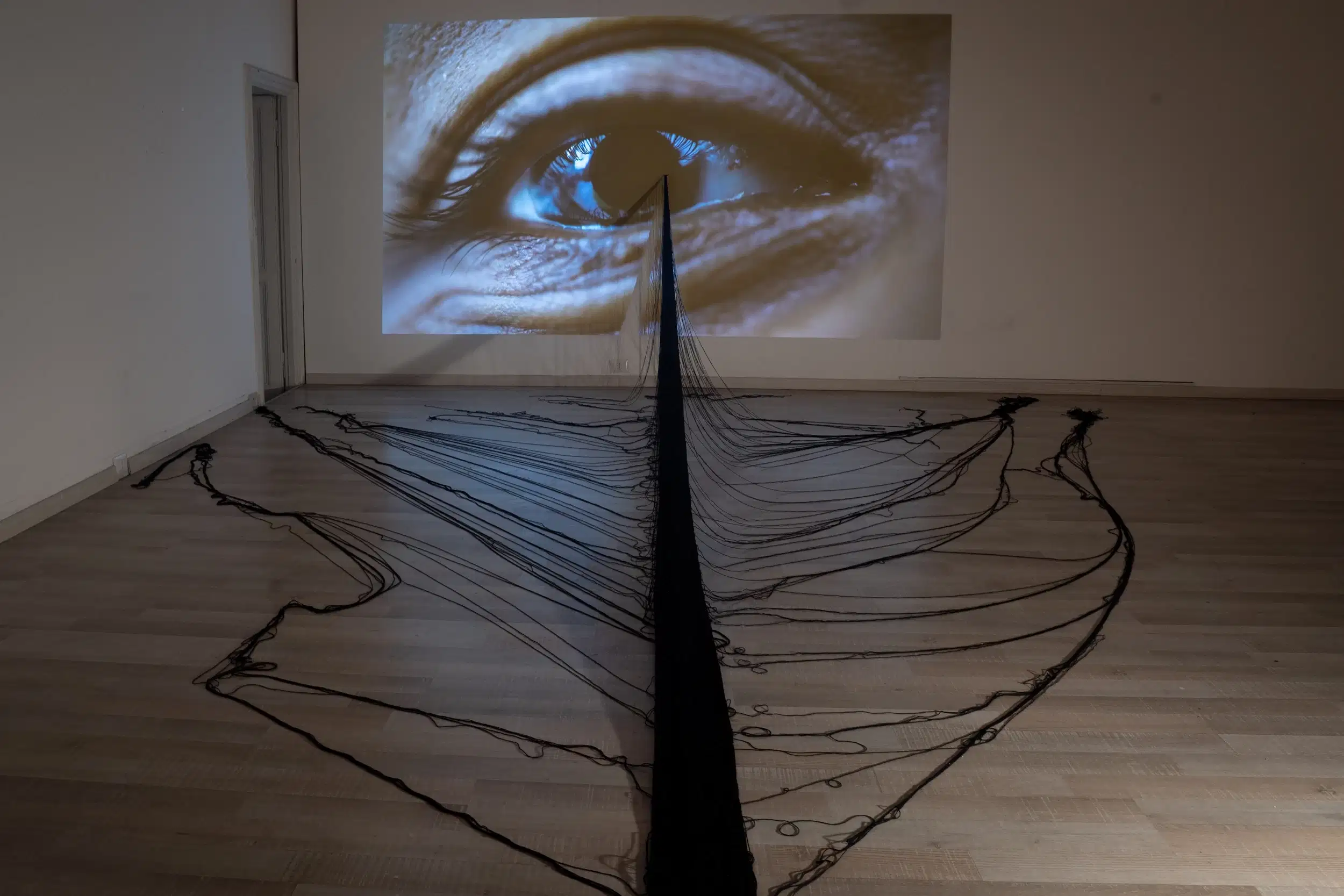 Jeanine Oleson, “In plane site”, 2024, installation includes hand-made cotton weaving and video projection 