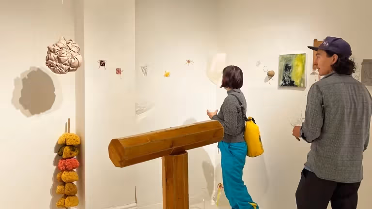 people looking at art in a studio