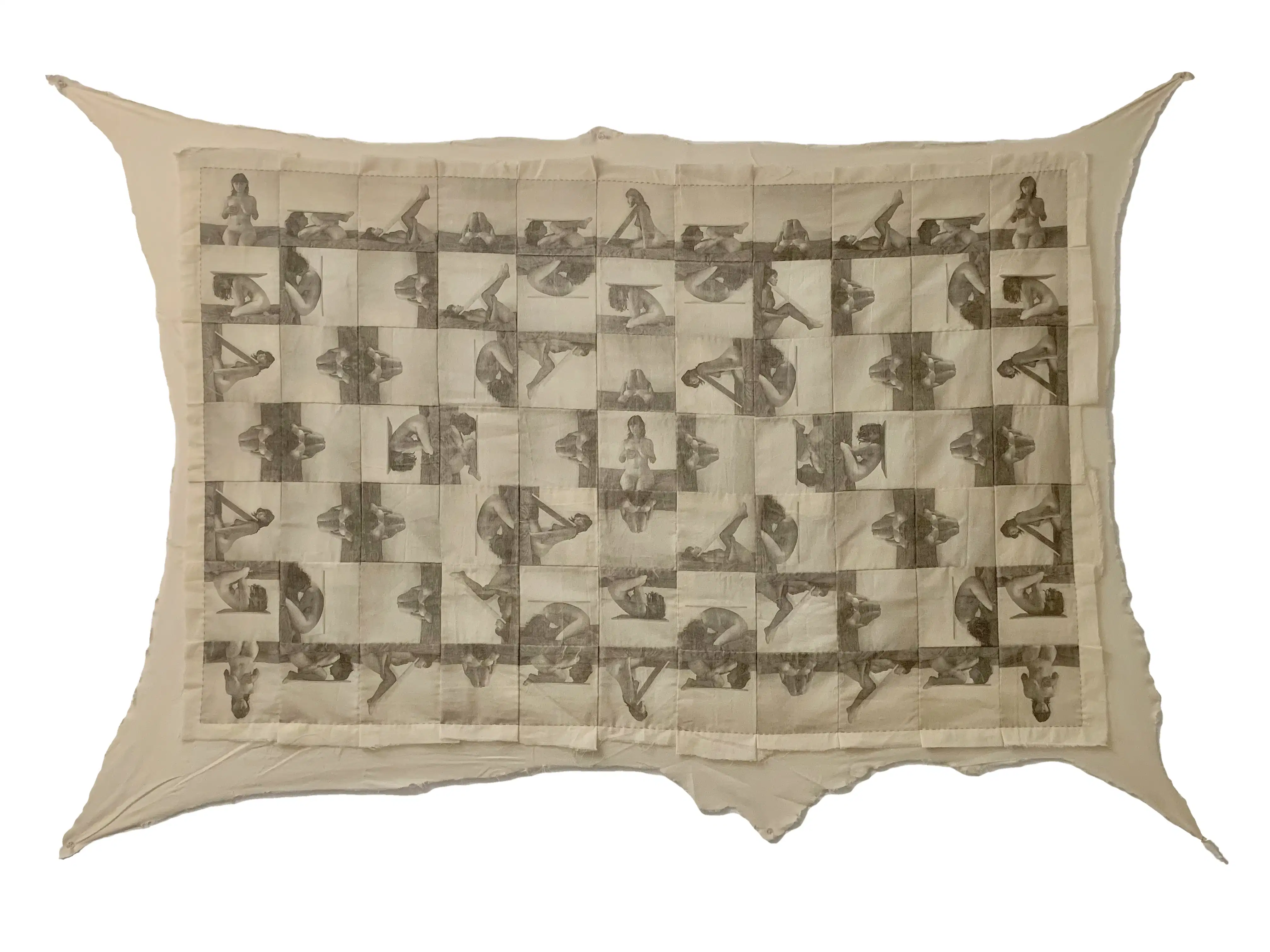 A quilt by Julia Colletes on view in BFA Visual & Critical Studies' Disclosed Studios Part Two. The quilt is made of a pattern of patches featuring an image of a feminine person in various seated positions.