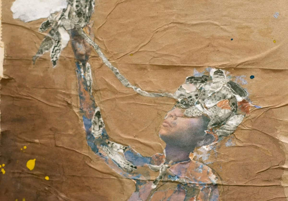 A detail of a collage by Savio Zigbi-Johnson. The collage shows a human figure with the right arm extended upwards to the sky. The background is brown paper.