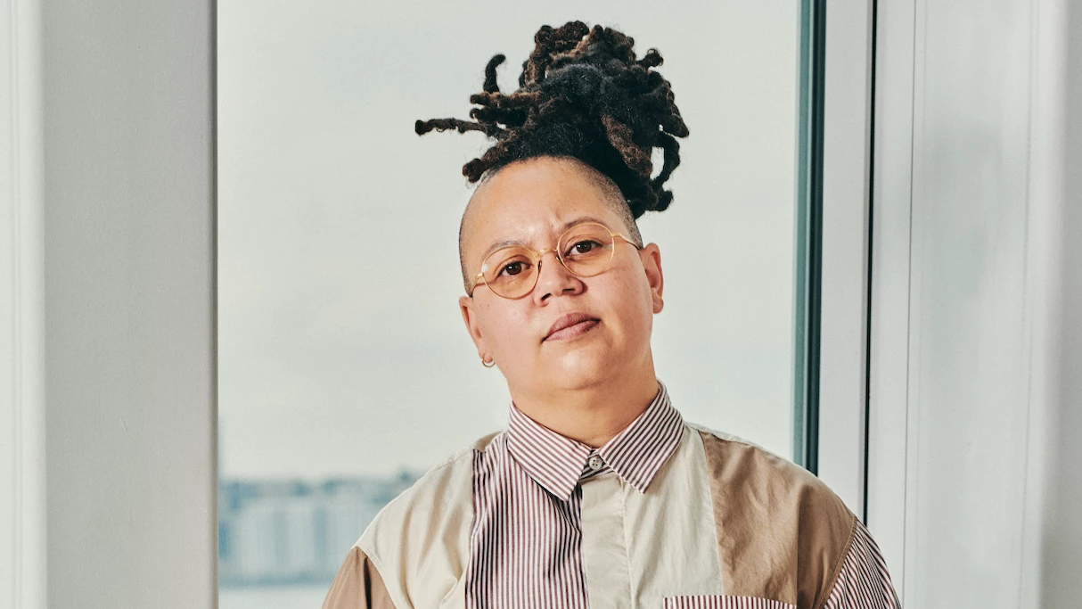 Photo of Meg Onli in dreadlock bun and button down shirt