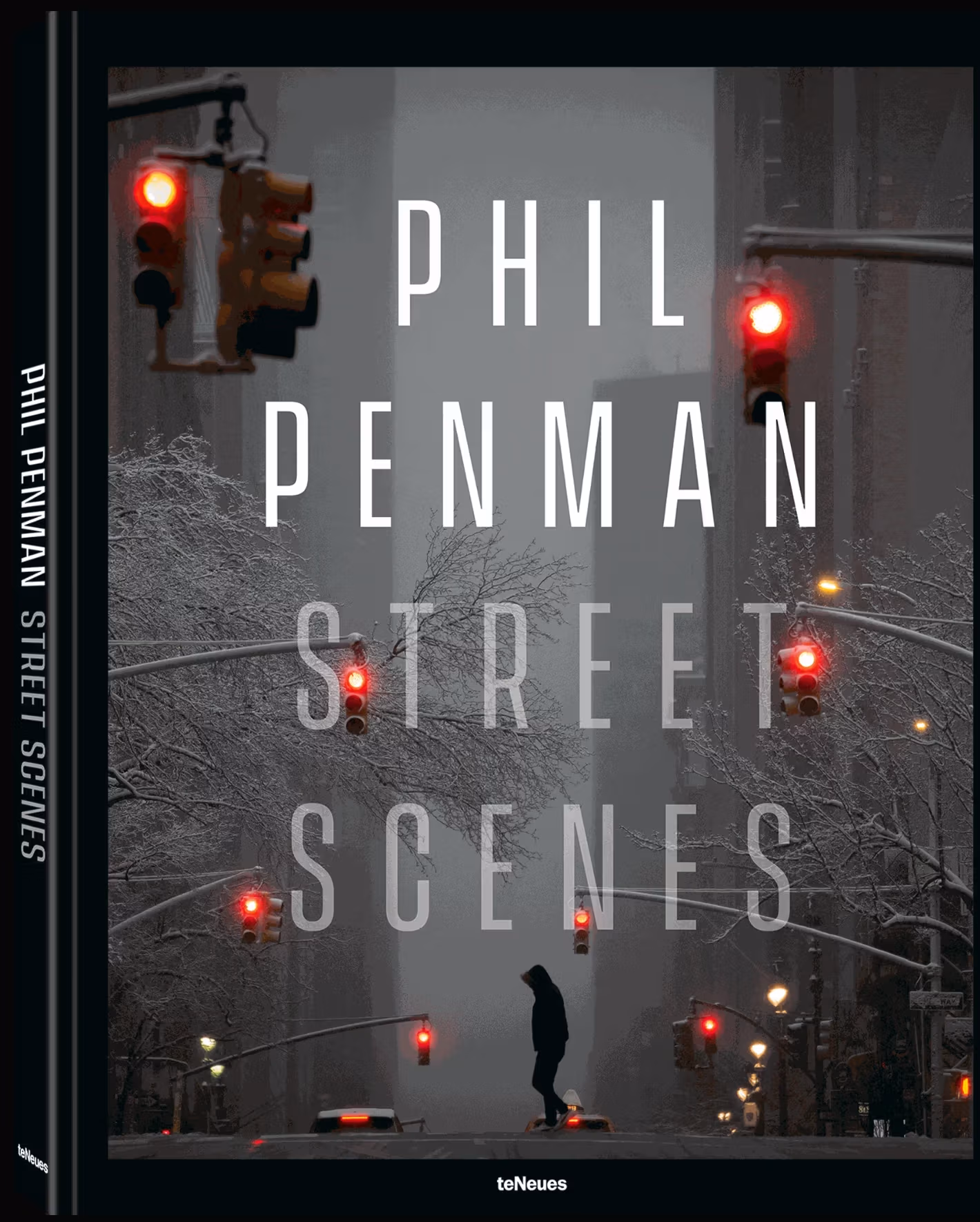 Cover of Phil Penman's book Street Scenes with a photograph of a person in silhouette crossing a showy Manhattan avenue with multiple red traffic lights visible.   
