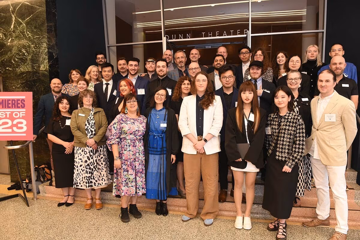 A large group of people standing together posing for a group photo.
